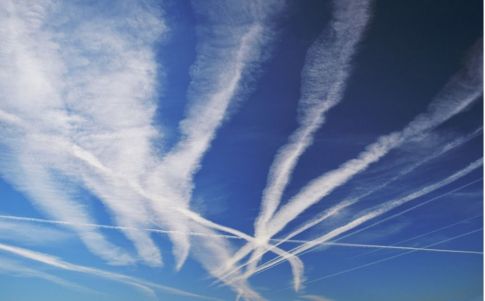 many chemtrails or contrails produced by airplanes flying on blue sky picture id1140839470 (1)